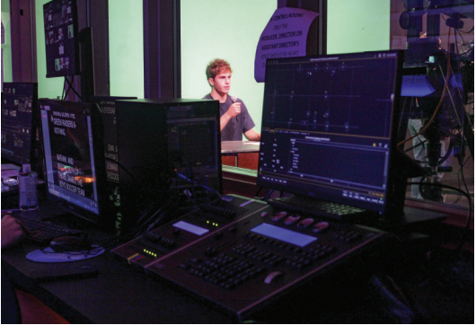 Under the spotlight: Lights shine down on senior Nathan Frazer as he presents a sports update on Good Morning ’Stoga. The TV studio received new lighting fixtures over the summer. A company will finish similar upgrades in the auditorium.